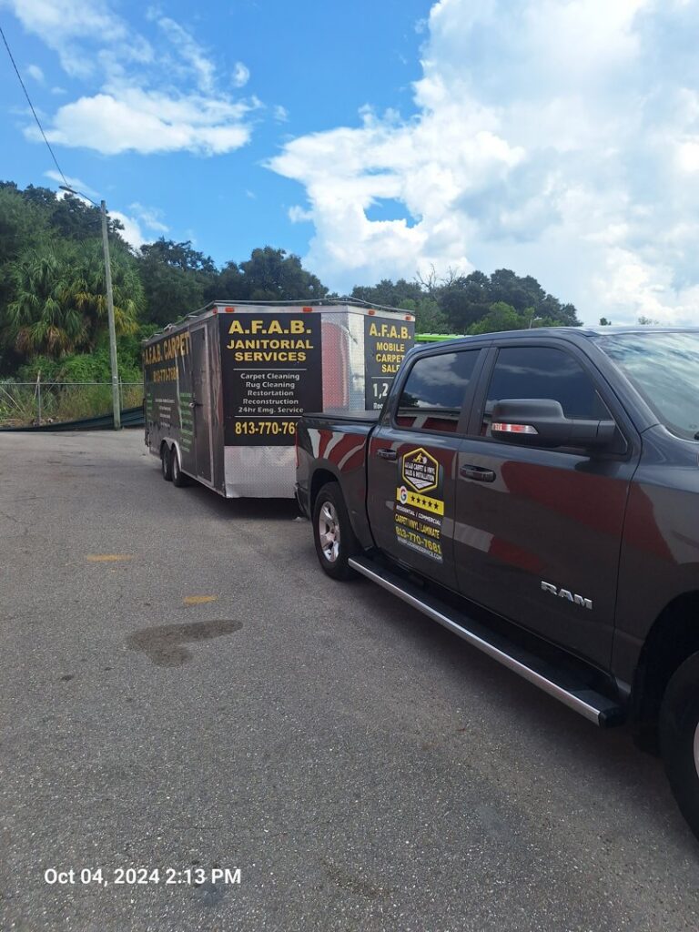 AFAB Carpets service truck and trailer, branded with services, parked in Tampa, FL.