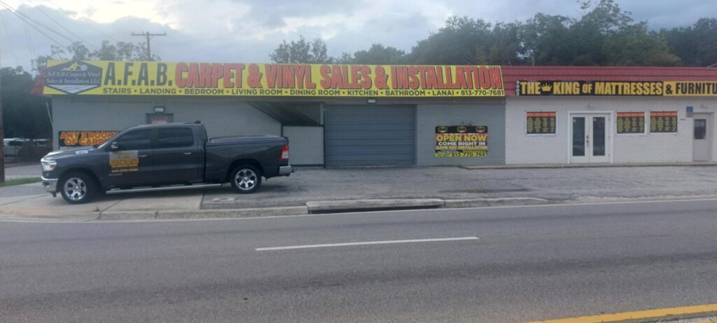 The storefront of AFAB Carpets & Vinyl Sales & Installation in Tampa, FL, showing business signage.