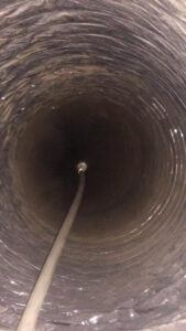 A view inside a flexible air duct showing a cleaning tool in action by Clean Air Solutions in Gaithersburg, MD.
