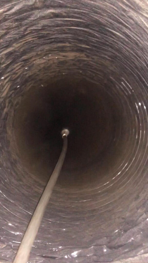 A view inside a flexible air duct showing a cleaning tool in action by Clean Air Solutions in Gaithersburg, MD.