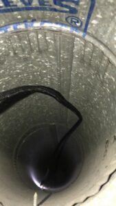 An air duct being inspected or cleaned with a specialized tool by Elementscarpetcleaning.net in Omaha, NE.