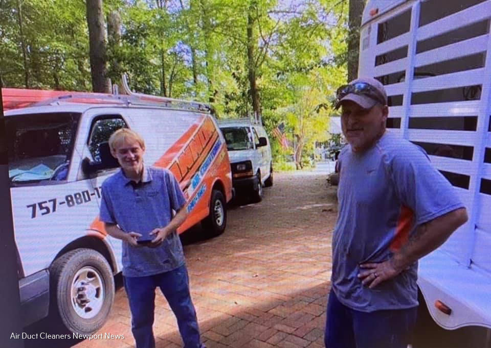 Air duct cleaning technicians standing next to their service van, representing Cannon Heating and Air Conditioning, LLC in Newport News, VA.