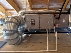 An air handler unit with flexible and rigid ductwork installed by QC Mechanical, Inc. in Lockport, NY.