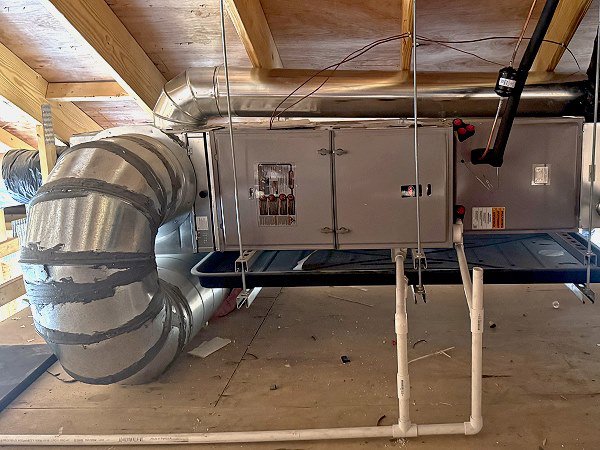 An air handler unit with flexible and rigid ductwork installed by QC Mechanical, Inc. in Lockport, NY.