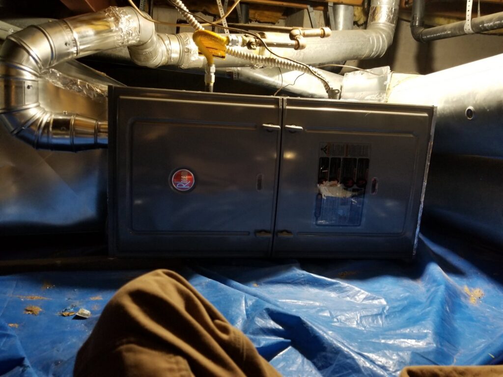 An air handler unit with ductwork installed in a residential space by Thin Air Heating & Cooling Repair in Arvada, CO.