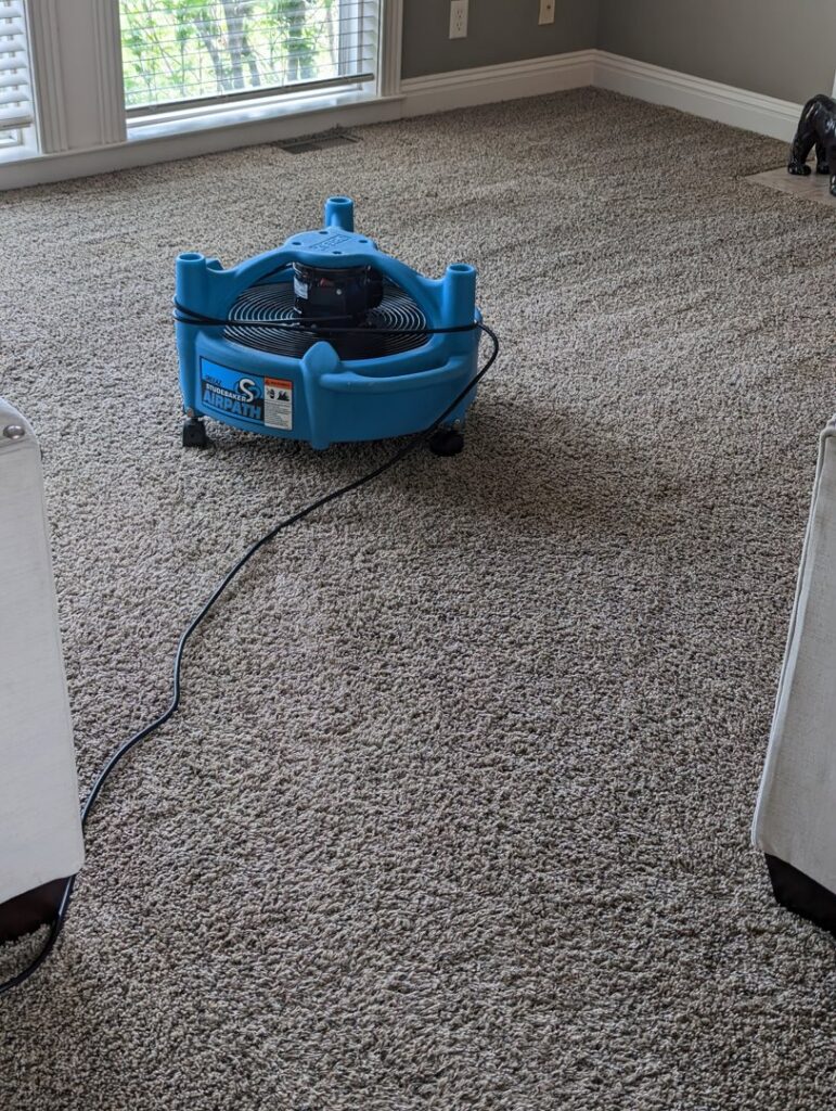 A blue air mover drying a carpeted room after cleaning by R&W Carpet Cleaning & Water Extraction in Independence, MO.