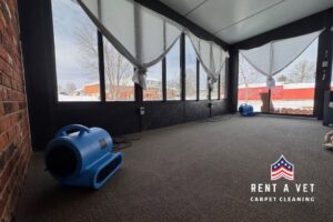 Blue air movers drying a freshly cleaned carpet in a sunroom by Rent A Vet Carpet Cleaning in St. Charles, MO.