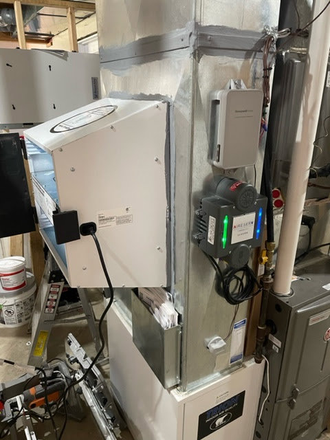 An air purifier installed as part of an HVAC system by Aire Serv of Fargo, ND.