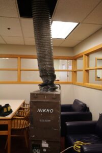 A large air scrubber and HEPA filter unit with ducting for air purification by Air Care & Restoration Co. in Bethlehem, PA.