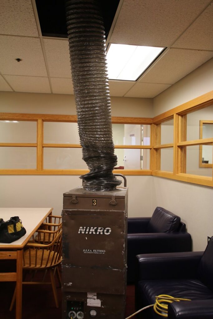 A large air scrubber and HEPA filter unit with ducting for air purification by Air Care & Restoration Co. in Bethlehem, PA.