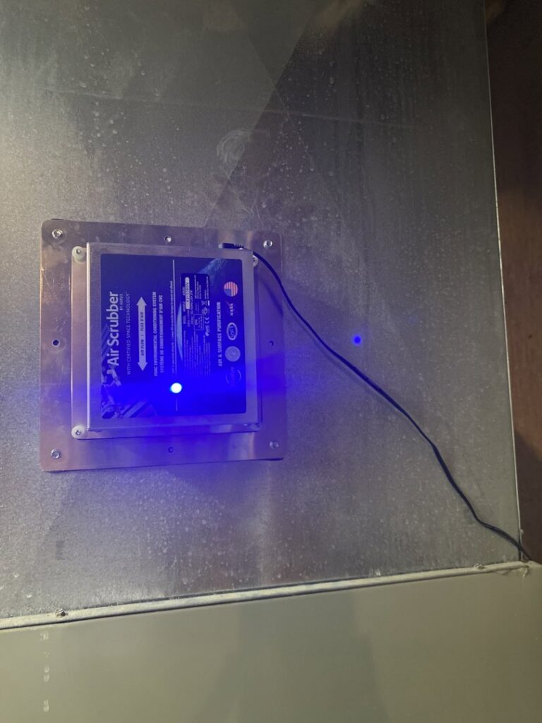 An Air Scrubber unit installed on ductwork, providing indoor air quality service by Cates Heating & Cooling in Lenexa, KS.