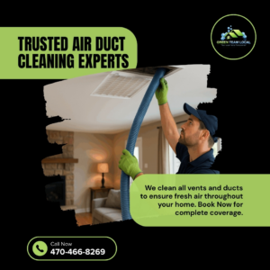 A Green Team Local expert cleaning a ceiling air vent with a large hose in a residential home in Page.