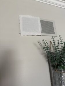 An air vent with a temporary cover for air leakage testing by Green Seal Energy in Overland Park, KS.