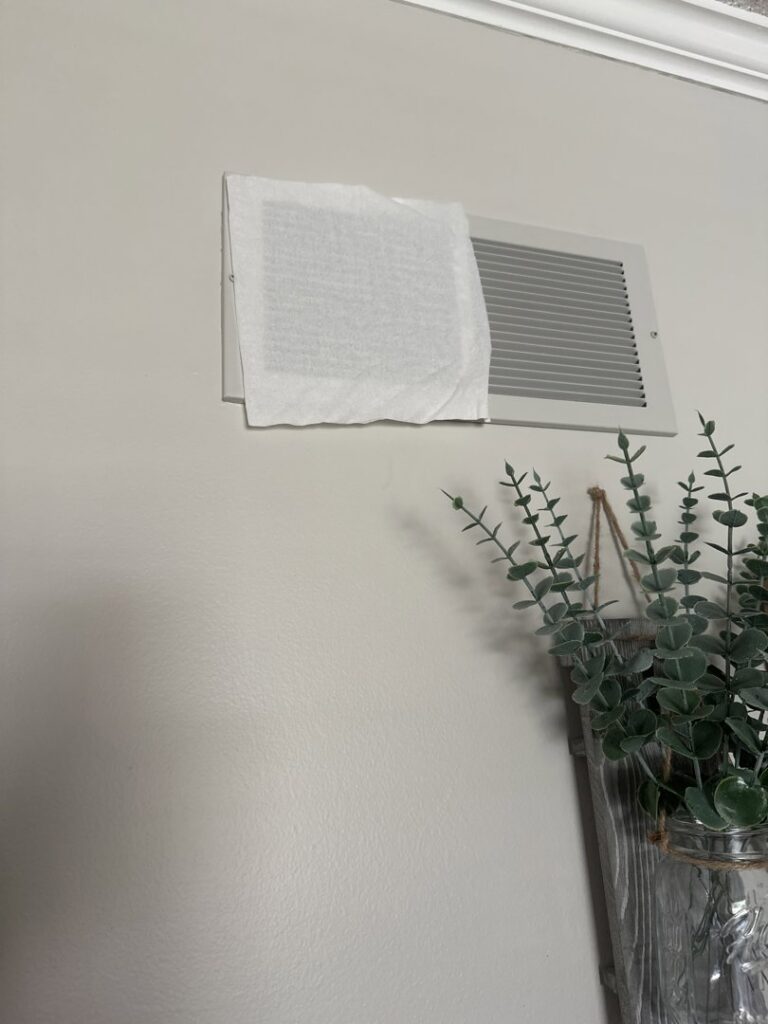 An air vent with a temporary cover for air leakage testing by Green Seal Energy in Overland Park, KS.