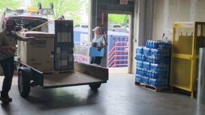 Aire Care Mechanical technicians loading American Pride HVAC equipment onto a trailer in Knoxville, TN.