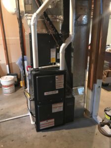 A newly installed or serviced Aire Serv HVAC furnace and air handler unit in a utility room in Billings, MT.