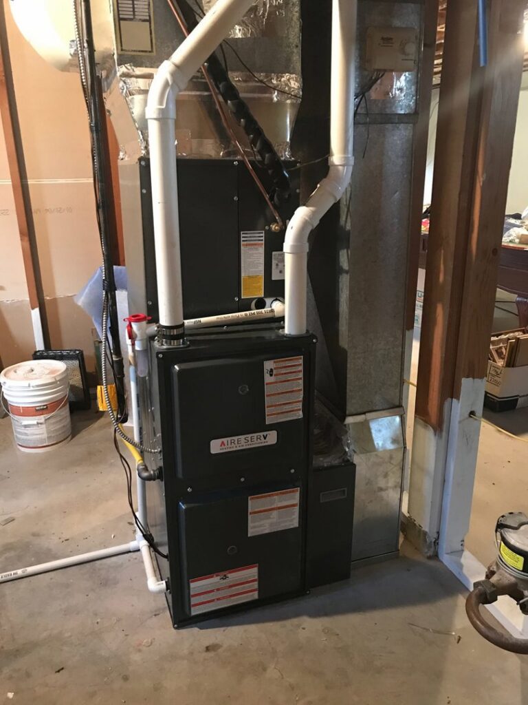 A newly installed or serviced Aire Serv HVAC furnace and air handler unit in a utility room in Billings, MT.