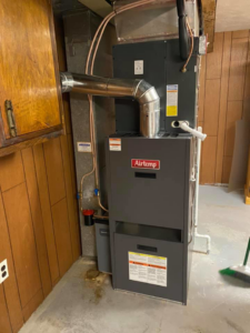 A newly installed Airtemp furnace and ductwork in a utility room by Albert DelPizzo HVAC in Newark, DE.