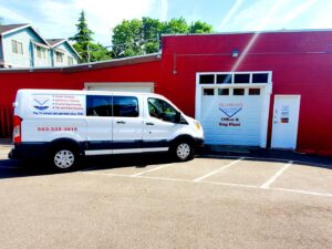 Alameda Carpet & Upholstery Cleaners service van parked outside their Office & Rug Plant in Portland, OR.