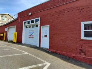 The main entrance and garage door of Alameda Office & Rug Plant building in Portland, OR.