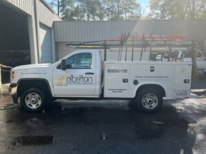A branded service truck with tools and ladders for Albritton Electrical Service, Inc. in Tallahassee, FL.