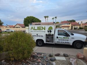 An Alien Air Conditioning and Heating service truck parked in a residential neighborhood in Phoenix, AZ, ready for a job.