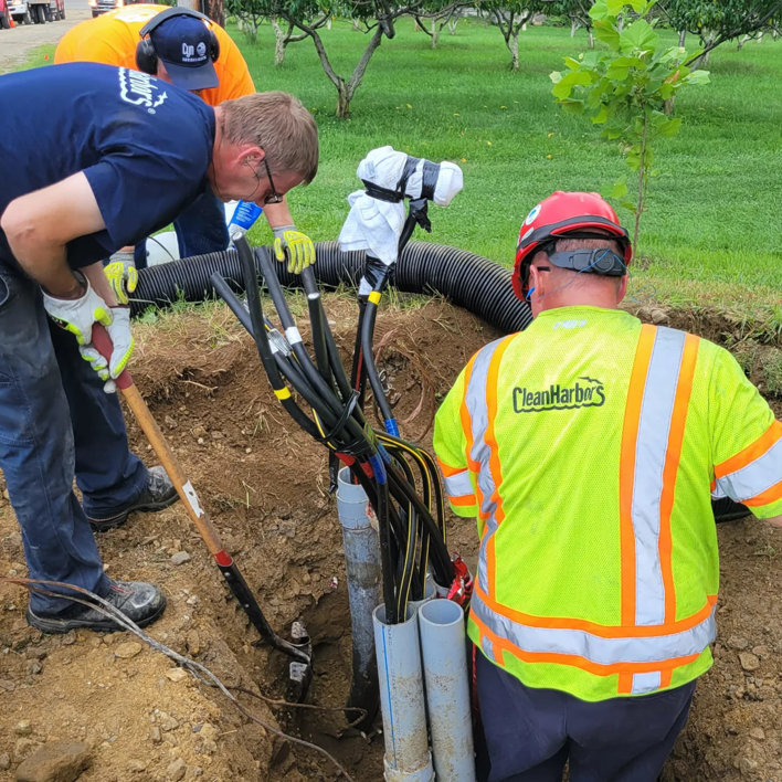 Alpha Electric LLC electricians connecting underground electrical cables in a trench in Dover, NH.