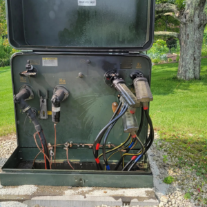 An open electrical transformer box showing internal cable connections, serviced by Alpha Electric LLC in Dover, NH.