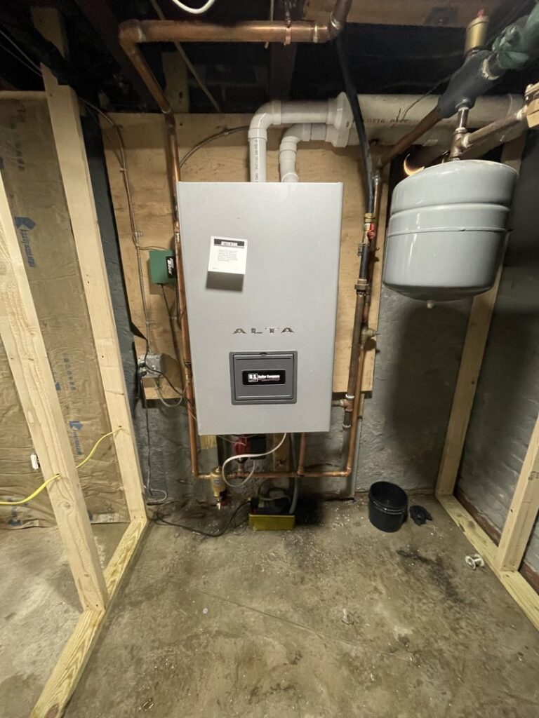 An Alta tankless water heater professionally installed on a wall by Alpine Pro Solutions in Allentown, PA.