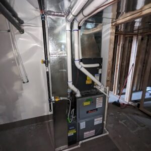 An Amana furnace and air handler system with ductwork and piping, installed by Inspector Rogers LLC in Draper, UT.
