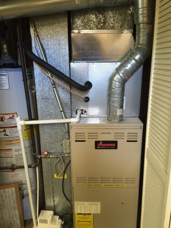 An Amana furnace and water heater installed in a utility closet by Any Climate Mechanical HVAC in Sandy, UT.