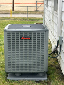 An Amana outdoor air conditioning unit installed next to a residential building by Dodrill Comfort & Energy Solutions in Cross Lanes, WV