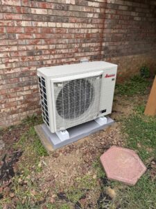 An Amana outdoor HVAC condenser unit installation by Gold Standard Heating and Cooling in Parkersburg, WV.