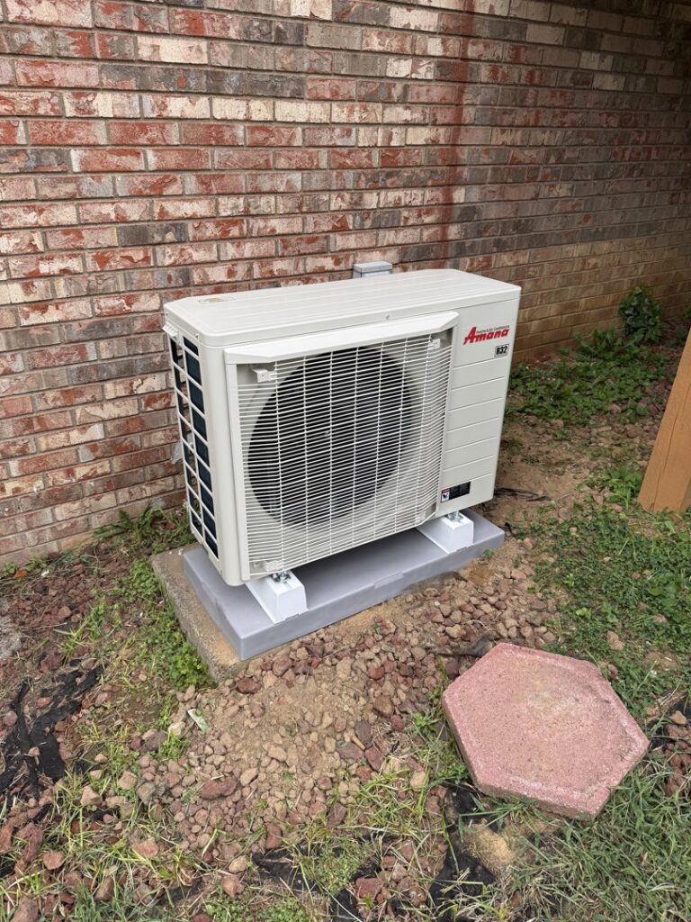 An Amana outdoor HVAC condenser unit installation by Gold Standard Heating and Cooling in Parkersburg, WV.