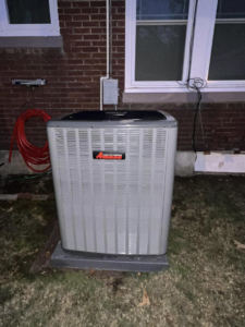 An Amana outdoor HVAC condenser unit installed next to a brick building by Smartcool Inc. in Pine Bluff, AR.