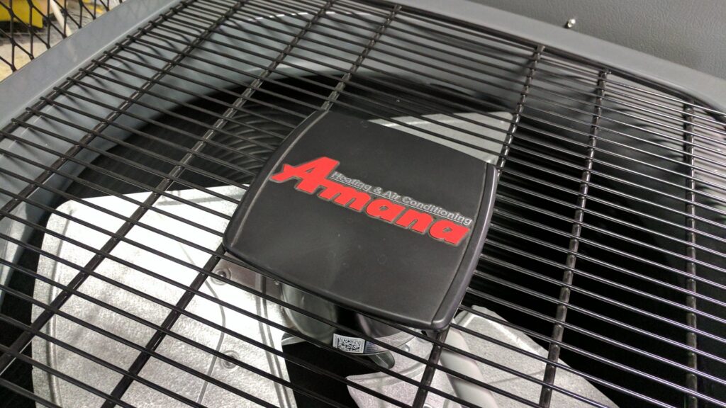 A close-up view of an Amana outdoor HVAC unit fan, serviced by Frederick Plumbing, Heating & Air Conditioning in Wichita, KS