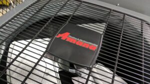A close-up view of an Amana outdoor HVAC unit fan, serviced by Frederick Plumbing, Heating & Air Conditioning in Wichita, KS
