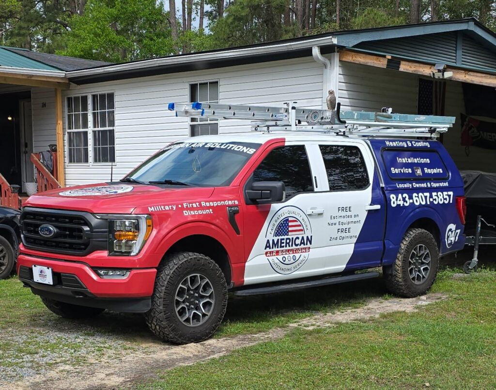 The American Air Solutions branded work truck parked on a gravel driveway in Summerville, SC, ready for an HVAC service appointment.