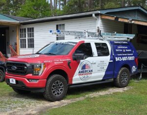 The American Air Solutions branded work truck parked on a gravel driveway in Summerville, SC, ready for an HVAC service appointment.