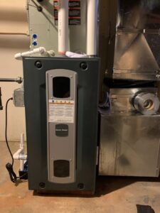An American Standard furnace and air handler unit with ductwork installed by Elite Mechanical in Manchester, NH.