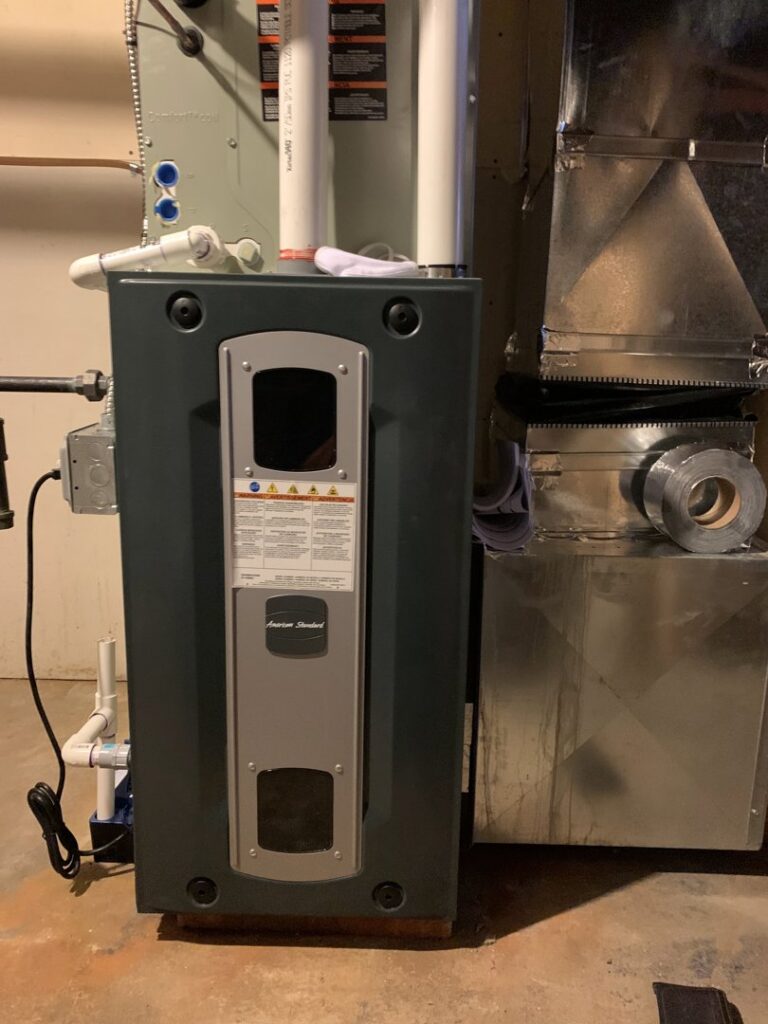An American Standard furnace and air handler unit with ductwork installed by Elite Mechanical in Manchester, NH.