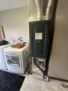 An American Standard furnace unit installed in a laundry room by Breezy Brothers Heating and Cooling in Lafayette, IN.