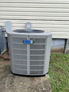 An American Standard outdoor AC unit installed next to a house by A/C Company Since 1988 in Murfreesboro, TN.