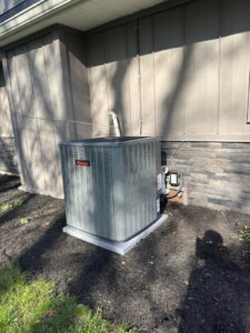 An American Standard outdoor AC unit installed next to a house by Breezy Brothers Heating and Cooling in Lafayette, IN.