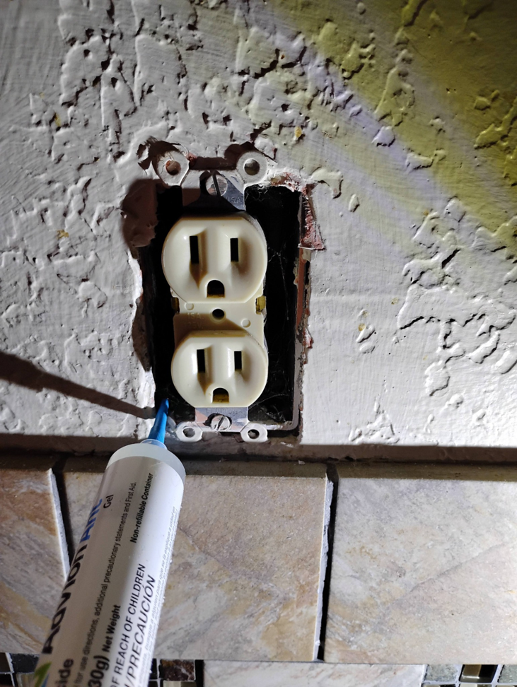 Applying ant gel bait into an electrical outlet for pest control by Pestpuncherspcs in Rio Rancho, NM.