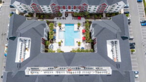 Aerial view of an apartment complex with a central pool area, showcasing electrical work by Performance Electrical Contracting Inc. in Jacksonville, FL