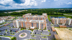 Aerial view of an apartment complex with solar panel installations by Performance Electrical Contracting Inc. in Jacksonville, FL