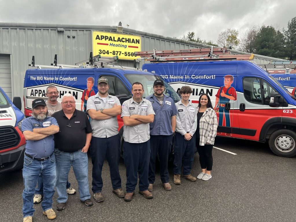 The Appalachian Heating HVAC team posing in front of their service vans, a proud part of Leap Partners in Greensboro, NC.