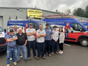 The Appalachian Heating HVAC team posing in front of their service vans, a proud part of Leap Partners in Greensboro, NC.