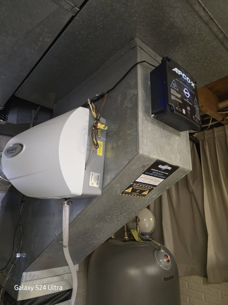 An Aprilaire humidifier and APCO-X air purifier installed on ductwork by Reliance Heating & Cooling in Yankton, SD.